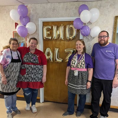 Staff celebrating Alzheimer's Awareness with balloons and decor
