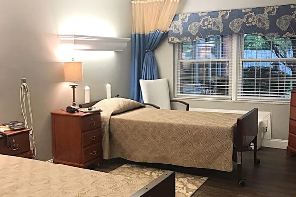 Private resident room with two beds and natural light