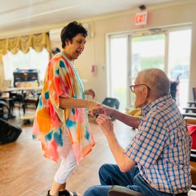 Residents dancing and enjoying an activity in a communal space