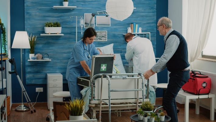 Healthcare professionals assisting a senior patient