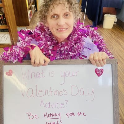 Resident sharing Valentine's Day advice with a sign