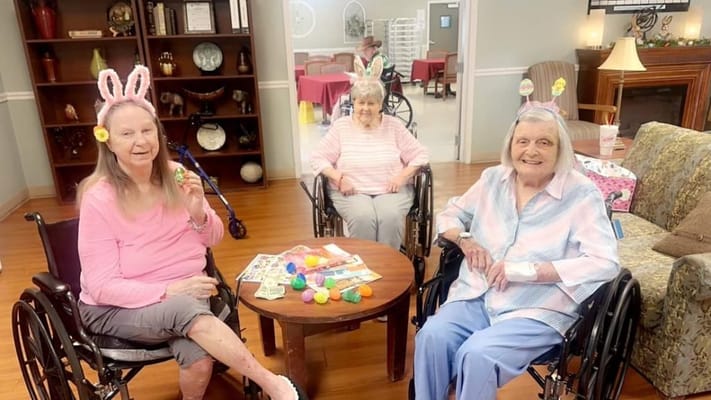 Three residents engaging in an activity indoors
