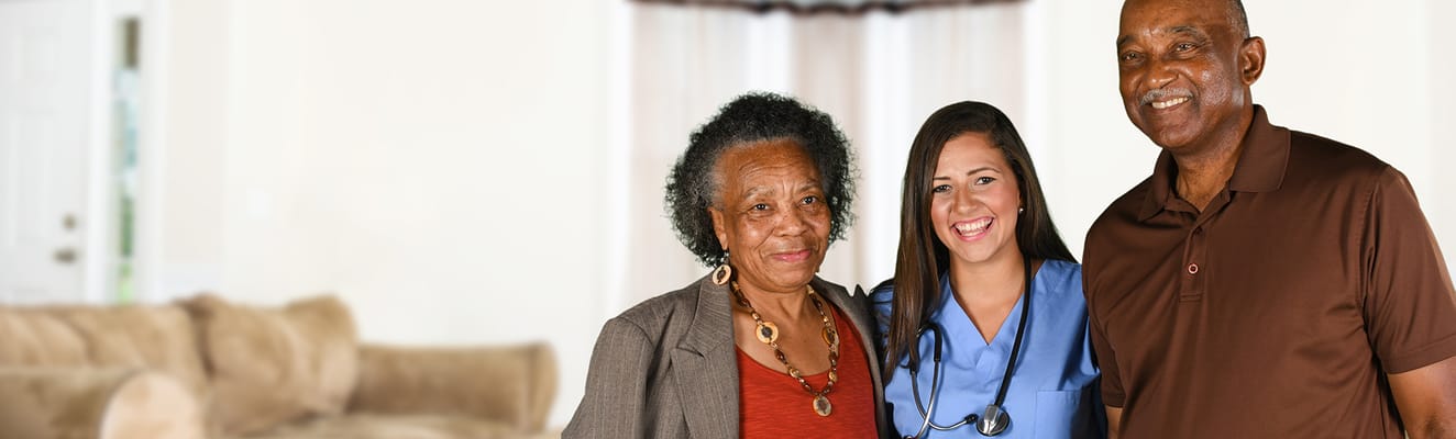 A caregiver with two residents in a cozy setting