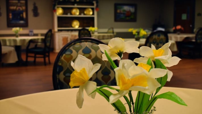 Decorative flowers on a dining table in a warm dining area
