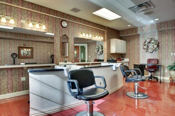Beauty salon area with styling chairs and decor