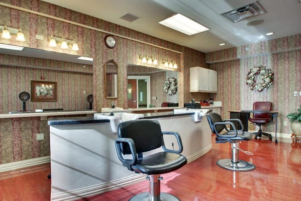 Beauty salon area with styling chairs and decor