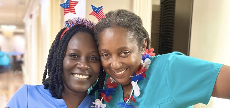 Two staff members celebrating with festive attire