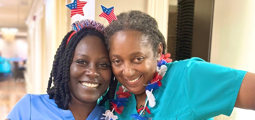 Two staff members celebrating with festive attire