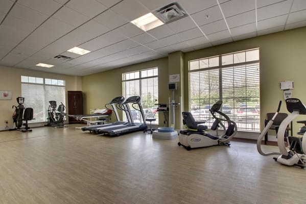 Well-equipped fitness room with exercise machines