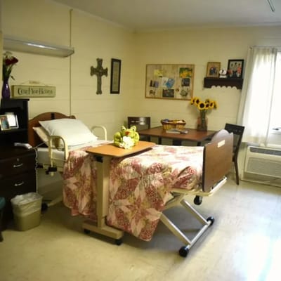A cozy resident room with bed and dining area