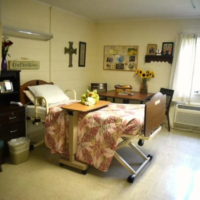 A cozy resident room with bed and dining area