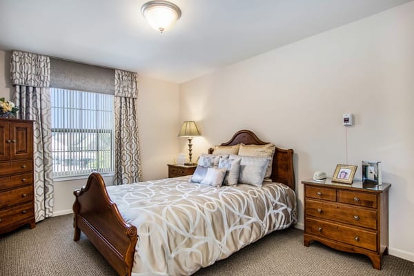 Cozy private bedroom with wooden furniture and window