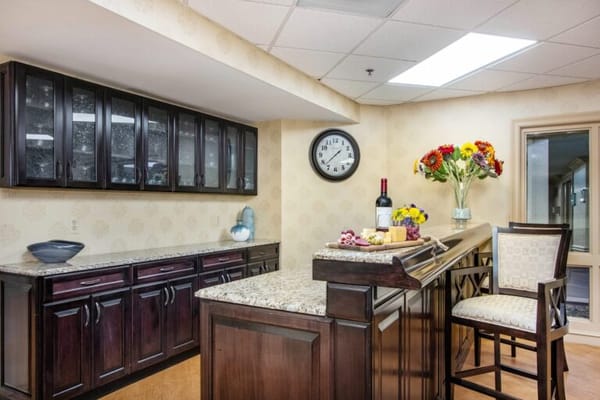 Bright interior common area with granite countertops and flowers