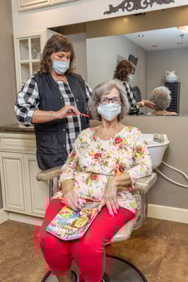 Resident receiving a haircut in the salon