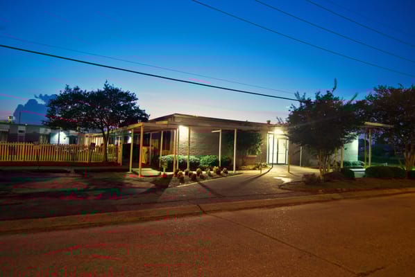 Exterior view of a senior living facility at dusk