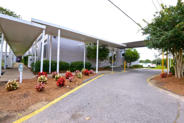 Entrance of a senior living facility with flowers