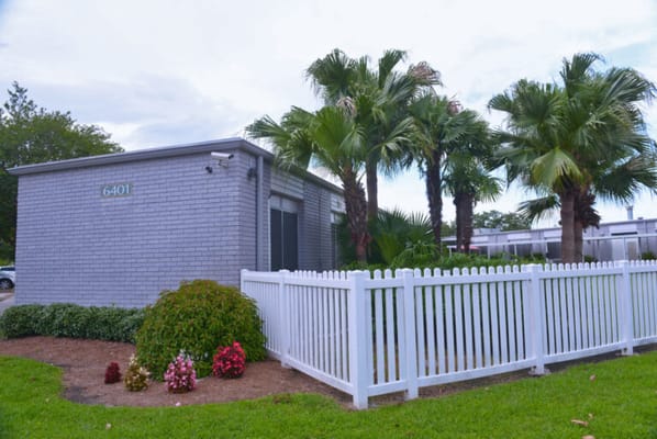 Exterior view of a facility surrounded by palm trees