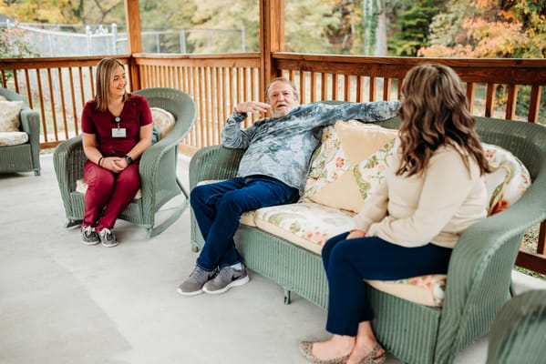 Residents and staff chatting on an outdoor patio
