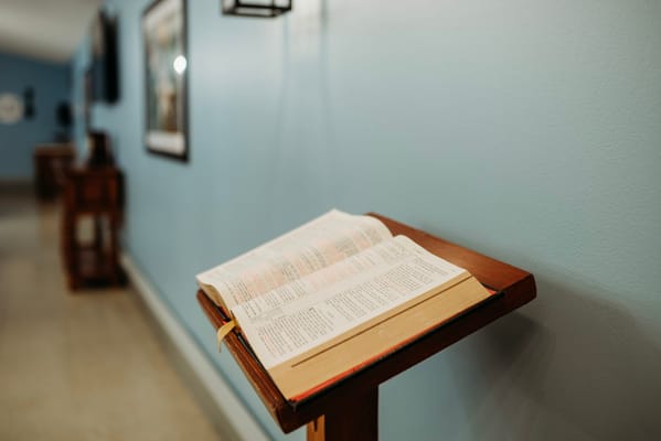 Open Bible on a stand in a hallway