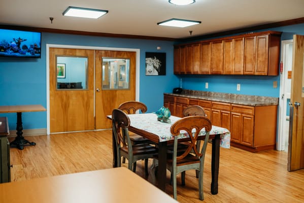Bright interior common area with dining table and kitchenette