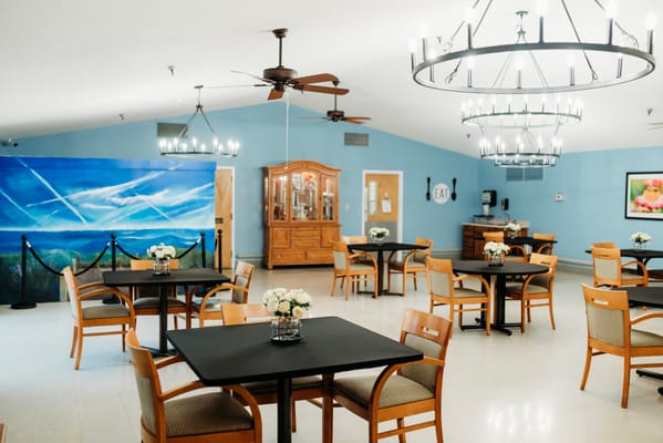 Bright dining area with tables and floral centerpieces