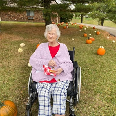 Resident enjoying a snack in a pumpkin field