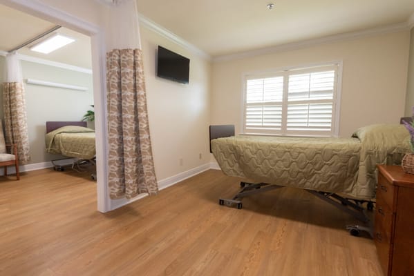 Well-furnished private resident room with bed and TV