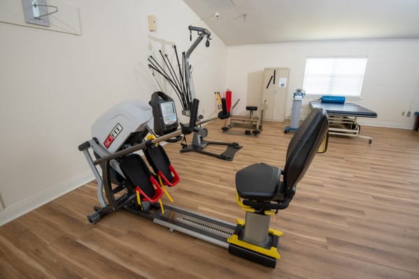 Rehabilitation gym equipment in a well-lit therapy room