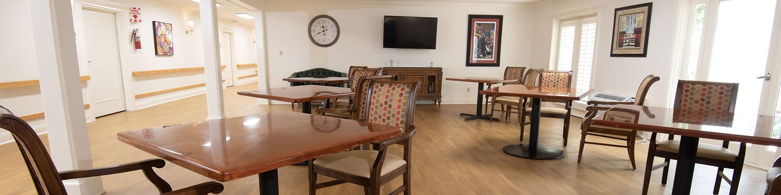 Bright dining area with wooden tables and chairs