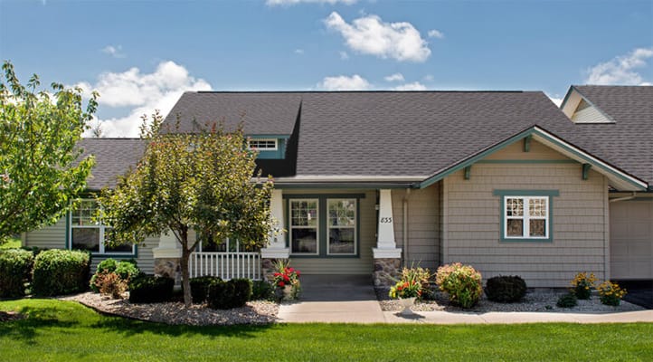 Exterior view of a senior living facility with landscaping