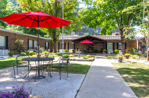 Outdoor courtyard with seating under red umbrellas