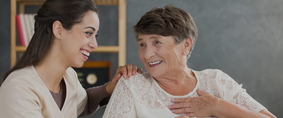 Staff member and resident sharing a joyful moment