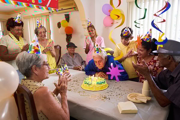 Residents celebrating a birthday with a cake