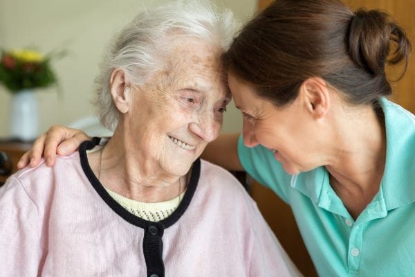 Caregiver and resident sharing a joyful moment