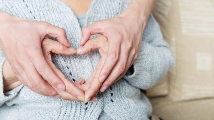 Two hands forming a heart shape together