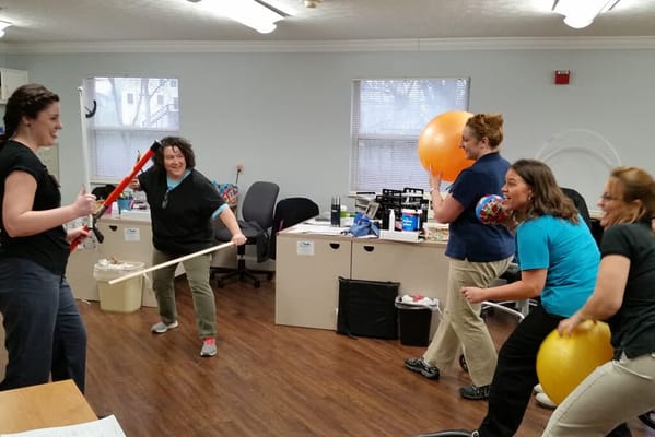 Staff engaging in a playful group activity indoors