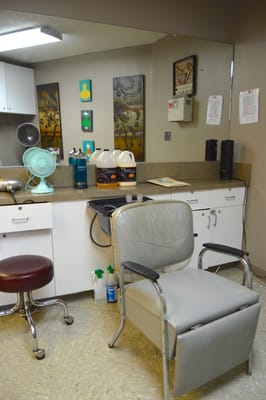 A salon area with chair and supplies