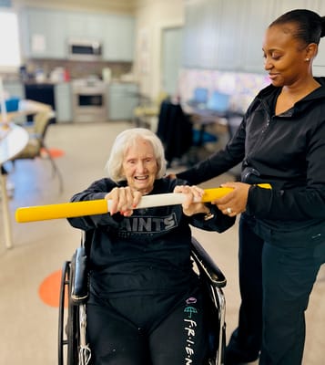 A resident and staff member engaged in physical activity