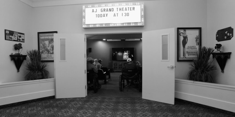 Entrance to the AJ Grand Theater filled with residents