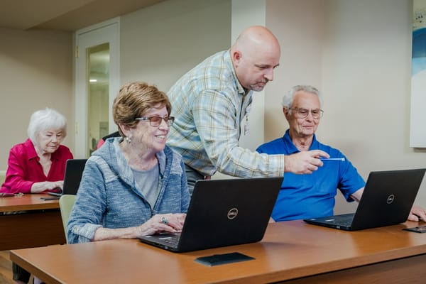Residents learning to use computers in a classroom setting