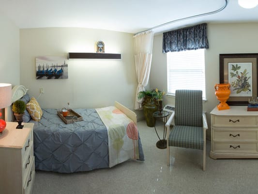 Cozy private resident room with bed and furniture