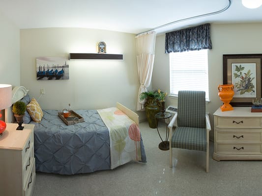 Cozy private resident room with bed and furniture