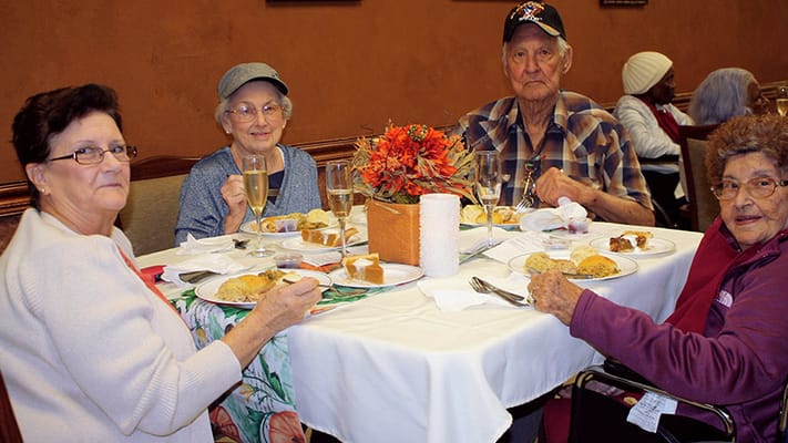 Residents enjoying a meal together in the dining room