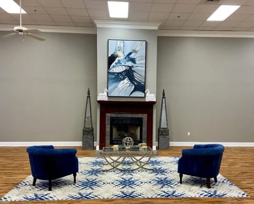 Inviting common area with blue chairs and art