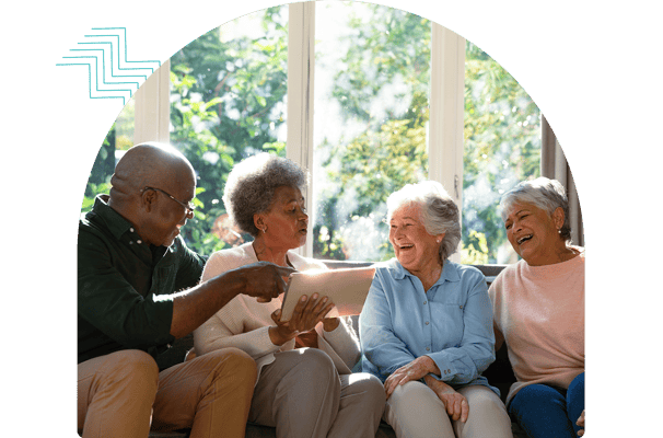 Residents enjoying a conversation in a sunny common area