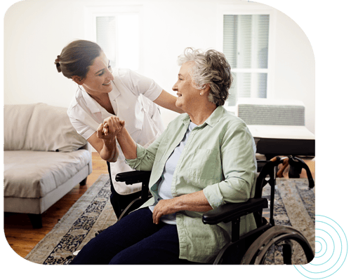 Caregiver assisting a resident in a cozy living space
