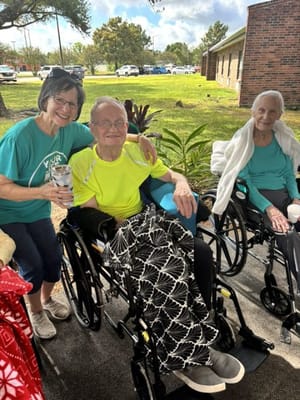 Residents enjoying time outdoors with a staff member