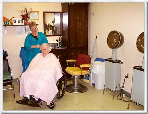 Resident getting a haircut in a salon area