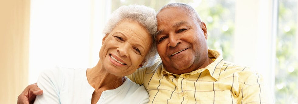 Couple smiling and sitting together in a bright room