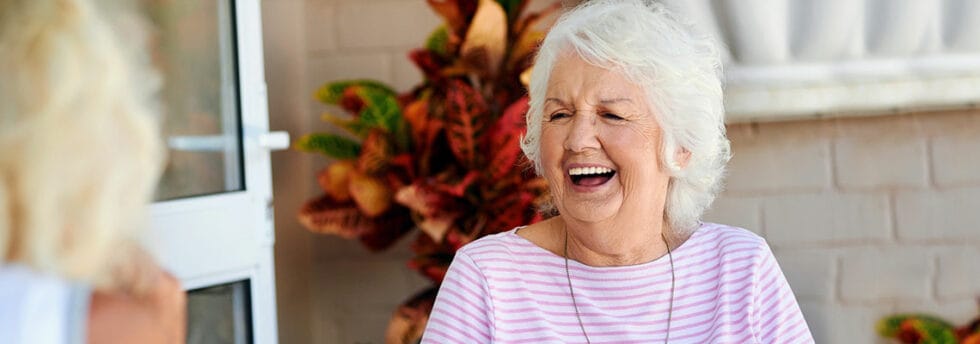Smiling senior woman enjoying a conversation outdoors